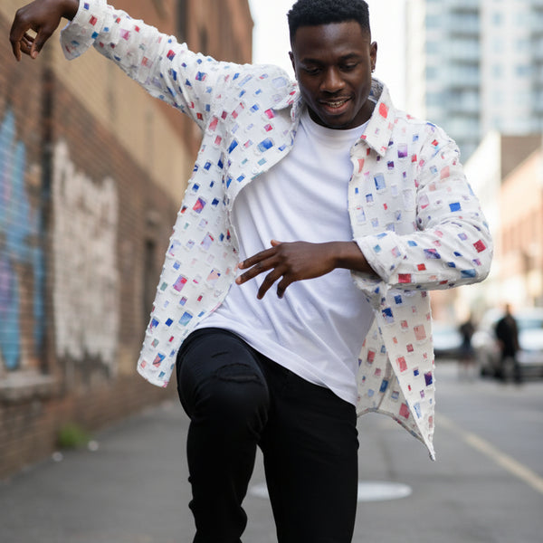 Colorful patterned shirt on a hanger against a gray background