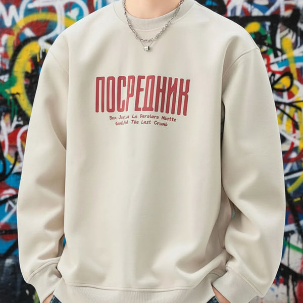 Person wearing a beige sweatshirt with red text on a white background