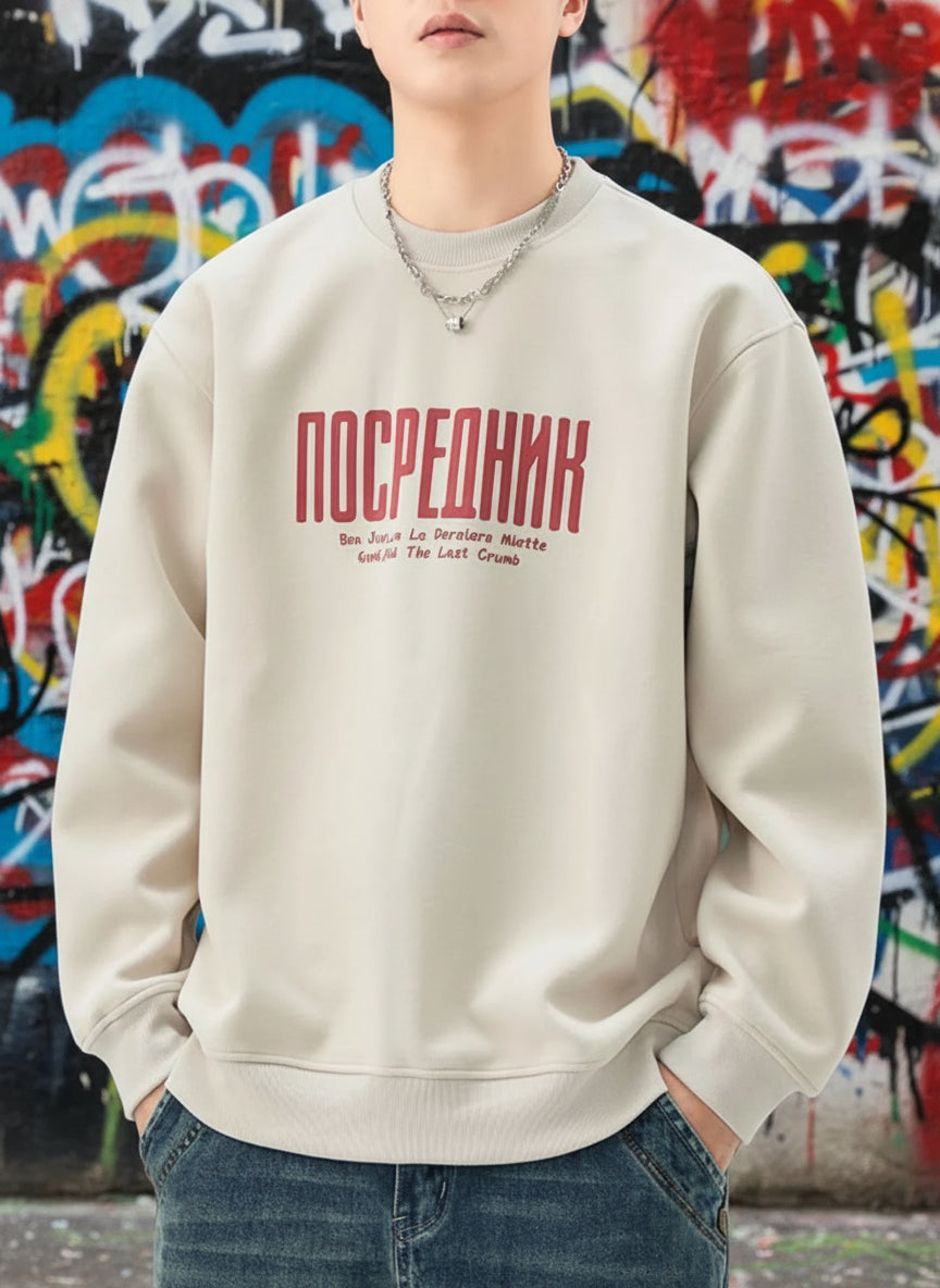 Person wearing a beige sweatshirt with red text on a white background